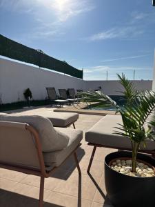 a patio with chairs and plants on a roof at villa HLH in Tangier