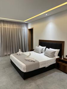 a bedroom with a large bed with towels on it at villa HLH in Tangier +19 photos