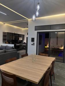a dining room and living room with a wooden table at villa HLH in Tangier