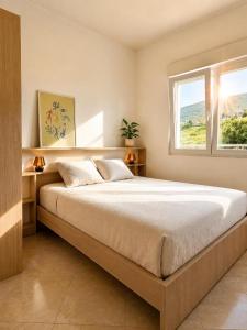a bedroom with a large bed and a window at PRCPORTOapartmani in Herceg-Novi