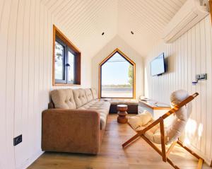 a living room with a couch and a window at OM Resort in Gura Teghii