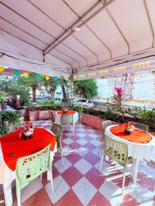 a patio with two tables and chairs with red table cloth at Hotel Central in Recife