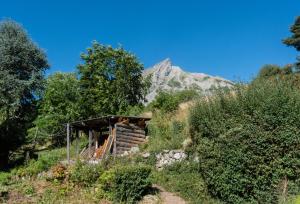 a building on a hill with a mountain in the background at La VilLaye in Laye