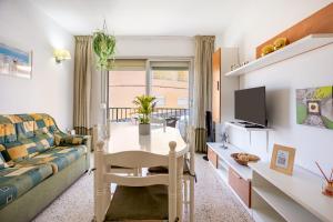 a living room with a table and a couch at Home2Book Sunny Terrace Apt, el Rincón de ManFe in Candelaria