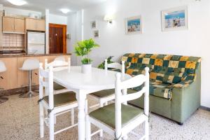 a kitchen and dining room with a white table and chairs at Home2Book Sunny Terrace Apt, el Rincón de ManFe in Candelaria +57 photos