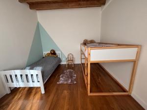 a bedroom with a bunk bed and a desk at Gîte de Fumouse in Le Mayet-de-Montagne