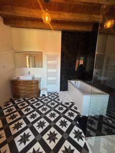 a bathroom with a tub and a sink at Gîte de Fumouse in Le Mayet-de-Montagne +26 photos