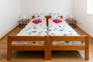 a bedroom with a bed with two pillows at Apartma Luketovi in Vojščica