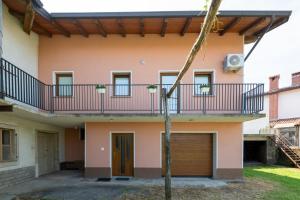a house with a balcony and a garage at Apartma Luketovi in Vojščica