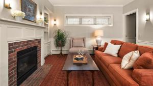 a living room with a couch and a fireplace at Green Mountain Inn in Stowe