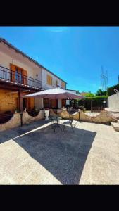 a table and umbrella in front of a building at Da Ross in Castel di Sangro