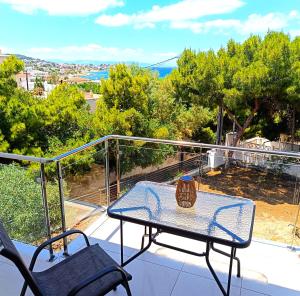 a table and chairs on a balcony with a view at Antigone Salty Studio in Vathí
