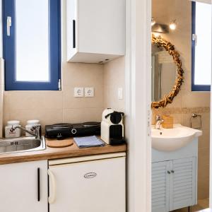 a small kitchen with a sink and a counter at Antigone Salty Studio in Vathí