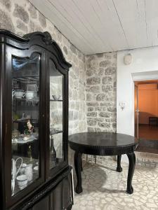 a dining room with a table and a cabinet at Villa Kotor Air in Muo