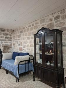 a living room with a blue couch and a cabinet at Villa Kotor Air in Muo