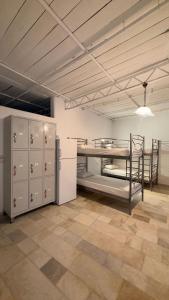 a room with two bunk beds and lockers in it at Hostel Naxos Camping in Naxos Chora