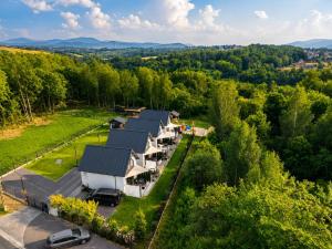 an aerial view of a house with cars parked in front at VeloDomki Żywiec - domki nad Jeziorem Żywieckim in Żywiec