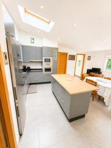 a kitchen with stainless steel appliances and a table at Apartamento As Caldelas in O Grove +6 photos