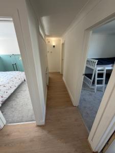 a hallway leading to a bedroom with a mirror at Channel side in Pevensey +12 photos