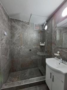 a bathroom with a shower and a sink at Villa Kotor Air in Muo +27 photos