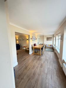 an empty living room with a table and a couch at Channel side in Pevensey