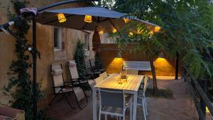 a table and chairs under an umbrella on a patio at Masoala Forest in Piera