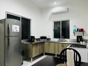 a kitchen with a stainless steel refrigerator and a stove at Tutis Home Domo-Estadio BBVA-ArenaMty Apart2dopiso in Monterrey +10 photos
