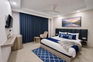 a bedroom with a king sized bed and a television at Hotel LA Costa, A Luxury Hotel In Haridwar in Haridwār