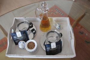 a tray of food on a glass table with a drink at Haus-Moewe-Jonathan-Wohnung-1 in Morsum +7 photos