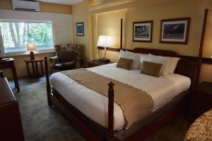 a hotel room with a large bed and a window at The Equus in Honolulu