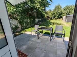 a patio with two chairs and a table on a patio at Hawthorn Studio - Self Contained One-Bed Studio Flat in Oxford