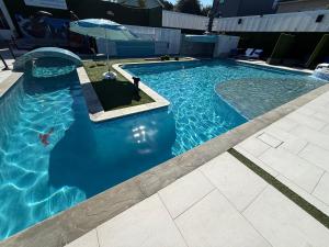 a large swimming pool with a blue pool at Blue Crawfish Boutique Hotel & Pool Bar in New Orleans