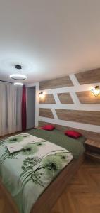 a bedroom with a large bed with a wooden wall at ApartHotel NoahResidence in Alba Iulia