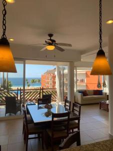 a dining room with a table and a view of the ocean at vivo resort in Chano