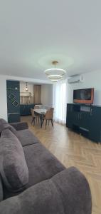 a living room with a couch and a table at ApartHotel NoahResidence in Alba Iulia