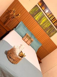 a bedroom with a bed with a basket on it at Rancho PJ - Presidente Juscelino-MA in Morros