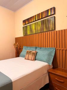 a bedroom with a bed with blue pillows on it at Rancho PJ - Presidente Juscelino-MA in Morros