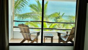 a view of a table and chairs from a window at Hotel Villa de Pescadores in Río Lagartos