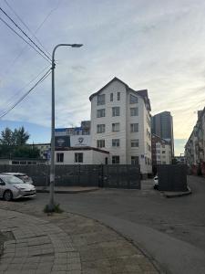 a street light in a parking lot next to a building at Mickey central 2 hostel in Ulaanbaatar