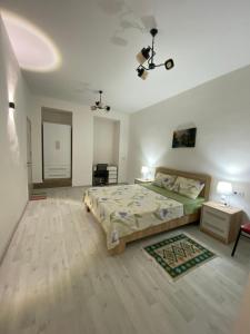 a bedroom with a large bed and a ceiling at Green Home on Mtatsminda in Tbilisi City