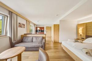 a living room with a couch and a table at Sonus Alpis - Adults Only in Castelrotto +94 photos