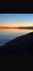 a view of a body of water at sunset at Saida guest house in Rybpunkt