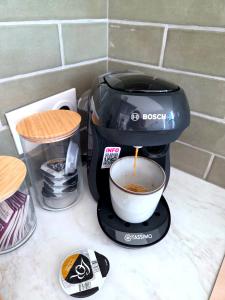 a coffee maker on a counter with a cup of coffee at Le Sargier in Levens +9 photos