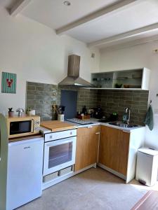 a kitchen with a sink and a stove top oven at Le Sargier in Levens