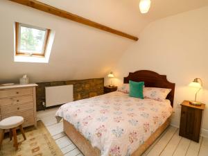 a bedroom with a large bed and a window at Childwall Cottage in Tullagher