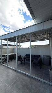 a patio with benches under awning on a building at Lighthouse Hotel in Gyumri
