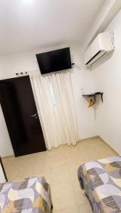 a room with a bed and a door with a window at Norita Alquiler Temporal - Departamento in La Rioja