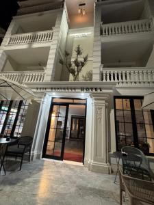a large white building with a revolving door at Hotel sefa brothers in Golem