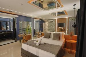 a bedroom with a large bed and a living room at Hotel Motel Sherwood in Porto Alegre