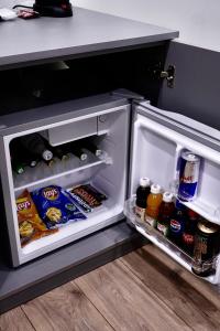 an open refrigerator with food and drinks in it at Lighthouse Hotel in Gyumri